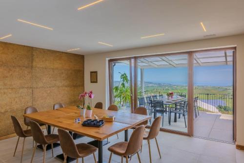 a dining room with a table and chairs and a balcony at Villa Laura in Atri