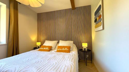 a bedroom with a bed with two pillows on it at Les Arches Beaujolaises in Belleville-en-Beaujolais