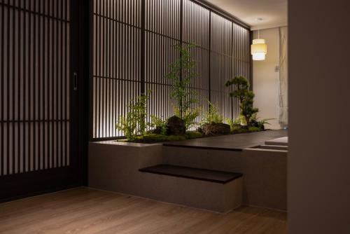 a room with a table with plants in it at Koum Ryokan Hotel Gijang by Aank in Busan