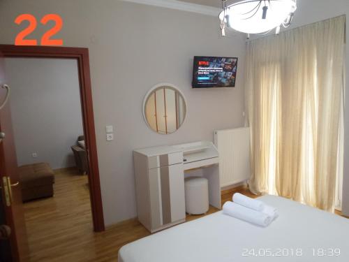 a small room with a bed and a mirror and a mirror at Kouros City Center in Kavala