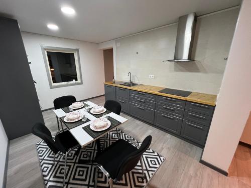 a kitchen with a table and chairs and a sink at Villa ICRE 23A in Överum
