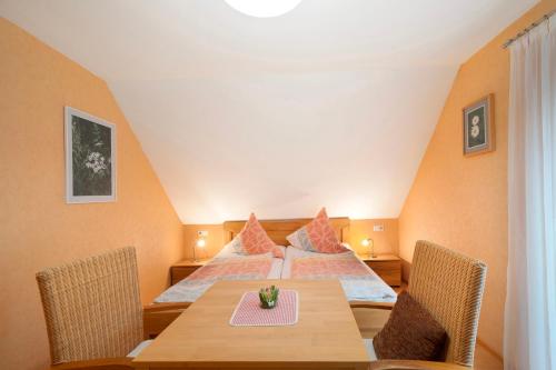 a room with a bed and a table and chairs at Grundhof in Oberprechtal