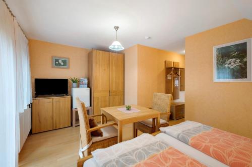 a room with a bed and a table in a room at Grundhof in Oberprechtal