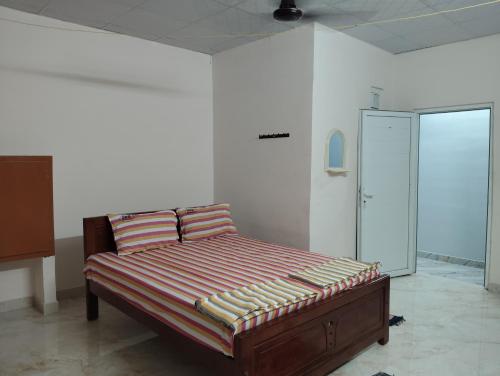 a bed with two pillows in a room at PPR Residency Pollachi in Pollāchi