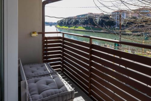 a balcony with a chair and a view of a river at Alla Riva in Verona
