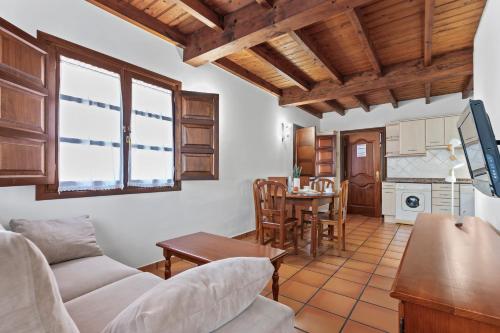 a living room with a couch and a table at Apartamentos El Rincón de Bustio in Bustio