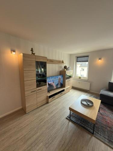 a living room with a couch and a coffee table at Am Stadtrand in Chemnitz