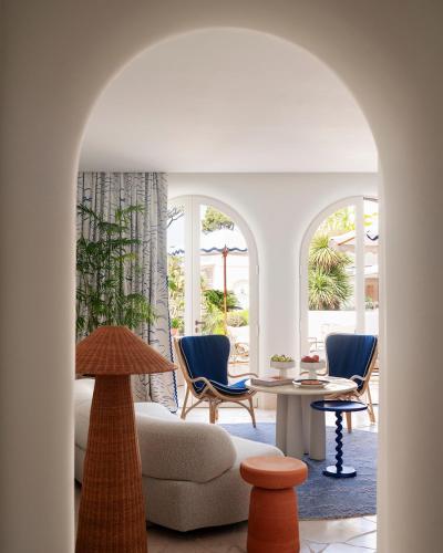 a living room with a couch and chairs and a table at Jumeirah Capri Palace in Anacapri