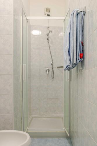 a bathroom with a shower with a toilet and a sink at Hotel POSTA - 2 stars - Comfortable Stay in Ventimiglia in Ventimiglia