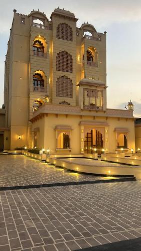 a large building with lights in front of it at Hotel Anand Bagh -Eraya Hotels in Phulera