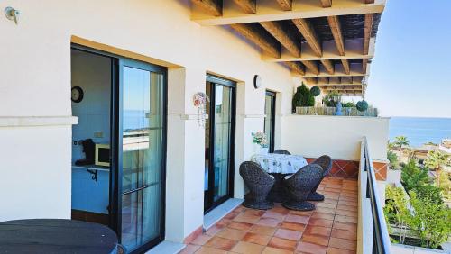 a patio with a table and chairs on a balcony at Costa Brisas in Almayate Alto