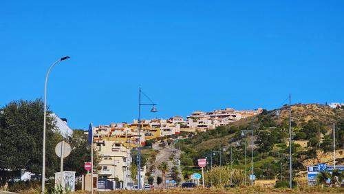 a building on the side of a hill at Costa Brisas in Almayate Alto