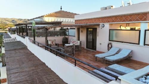 a balcony of a house with a patio at Costa Brisas in Almayate Alto