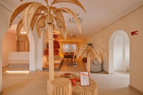 a palm tree in the middle of a room at Sunset Oasis Ibiza Adults Only - New Rooms 2025 in San Antonio Bay