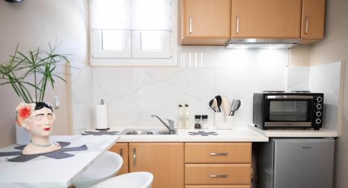 a kitchen with a statue of a woman on the counter at Cozy Boutique in Vrahati