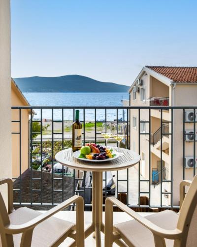 a plate of fruit on a table on a balcony at Boutique Hotel Villa Royal in Tivat