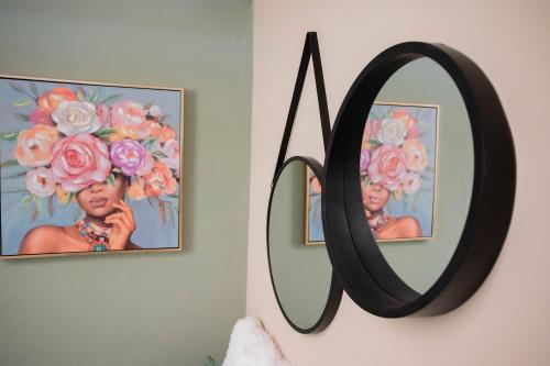 a mirror on a wall with a picture of a girl at Cozy Boutique in Vrahati