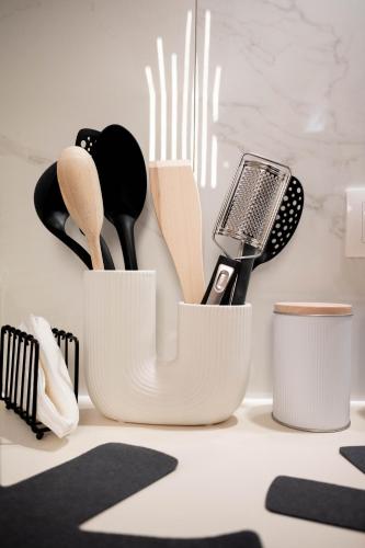 a group of utensils in white containers on a counter at Cozy Boutique in Vrahati
