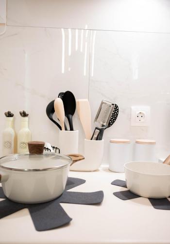 a kitchen counter with a bunch of kitchen utensils at Cozy Boutique in Vrahati