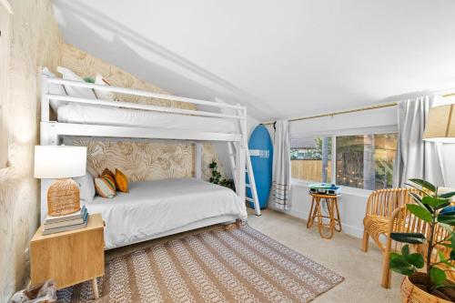 a bedroom with a bunk bed and a table with a lamp at Dream Stay! Pool, Hot Tub, PacMan,Foosball and More! in Oceanside