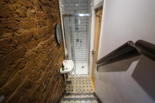 a small bathroom with a shower and a toilet at St Athans Hotel in London
