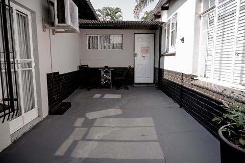 a hallway of a building with a white door and windows at Reveuse in Pretoria