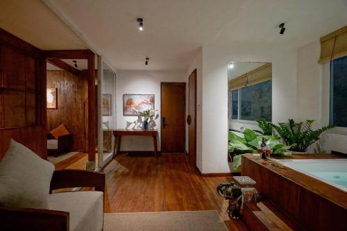 a living room with a bath tub and a couch at Nexus House Lang Bao Chi in Ho Chi Minh City
