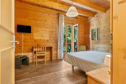 a bedroom with a bed in a wooden cabin at Agritur El Casel in Brentonico