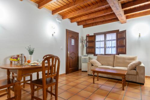a living room with a couch and a table at Apartamentos El Rincón de Bustio in Bustio