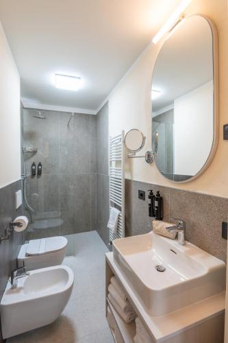 a bathroom with a sink and a mirror at WANDERLUST HOTEL - SUITE & SPA - APARTMENTS & VILLAS - Bardolino, Lago di Garda - Verona in Bardolino