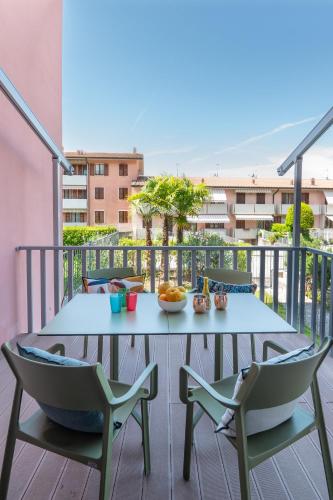 a table and chairs on the balcony of a apartment at WANDERLUST HOTEL - SUITE & SPA - APARTMENTS & VILLAS - Bardolino, Lago di Garda - Verona in Bardolino
