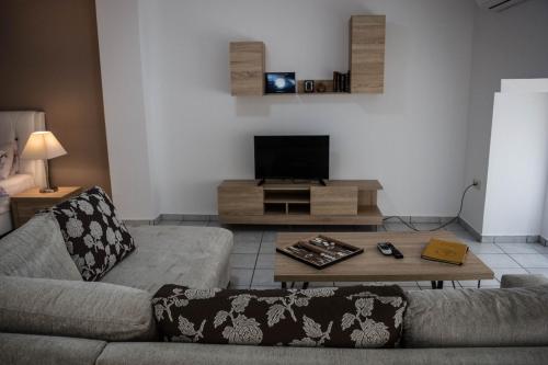 a living room with a couch and a coffee table at Kouros City Center in Kavala