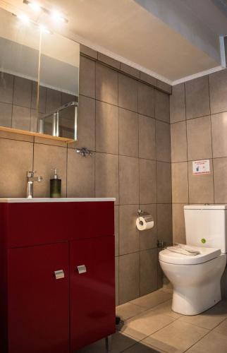 a bathroom with a toilet and a sink and a mirror at Kouros City Center in Kavala