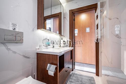 a bathroom with a sink and a mirror at Villa Sunset by EvTatilim Bodrum, Yalikavak in Bodrum City