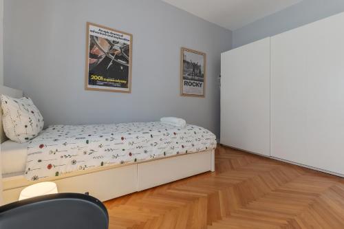 a bedroom with a bed with a poster on the wall at Ana & Roman Guesthouse - Beautiful Garden, Kid friendly in Oradea