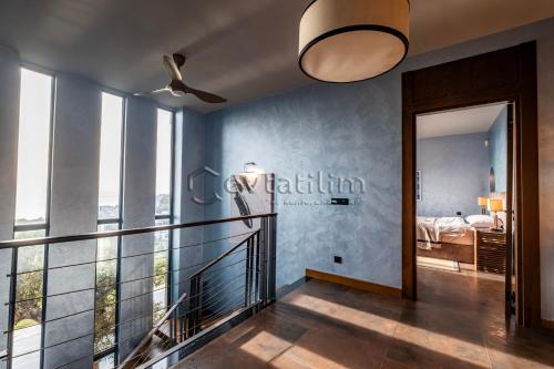 a hallway with a balcony with a bed and a bedroom at Villa Sunset by EvTatilim Bodrum, Yalikavak in Bodrum City