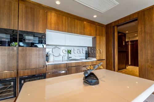 a kitchen with wooden cabinets and a large window at Villa Sunset by EvTatilim Bodrum, Yalikavak in Bodrum City