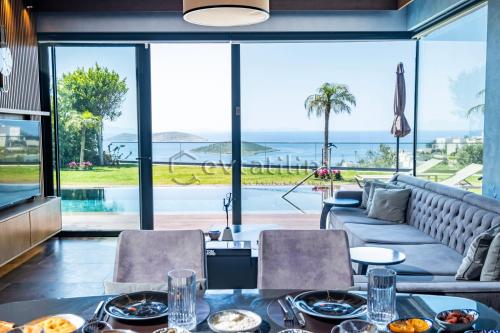 a dining room with a view of the ocean at Villa Sunset by EvTatilim Bodrum, Yalikavak in Bodrum City