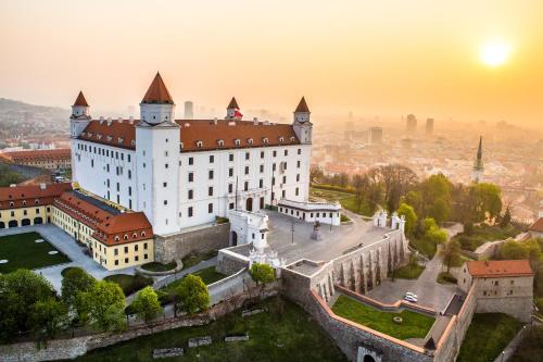an aerial view of neuschwanstein castle at sunset at MATADOR apartment & Free Parking in Bratislava
