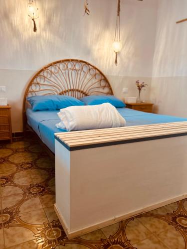 a bedroom with a large bed with blue pillows at Dream Holiday in Marina di Lizzano