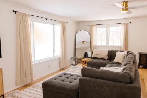a living room with a couch and a large window at The House On Kings Corner in Mansfield