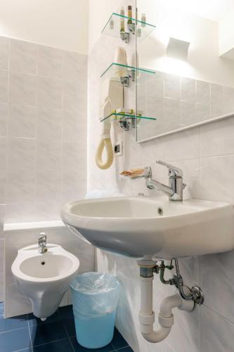 a bathroom with a sink and a toilet at Hotel POSTA - 2 stars - Comfortable Stay in Ventimiglia in Ventimiglia