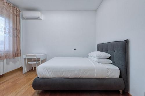a bedroom with a bed with a chair and a table at Paleocapa Apartments in Venice