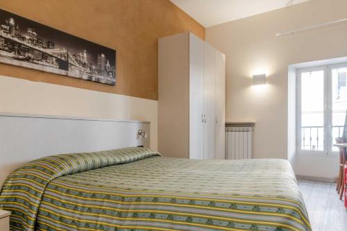 a bedroom with a large bed in a room at Hotel POSTA - 2 stars - Comfortable Stay in Ventimiglia in Ventimiglia