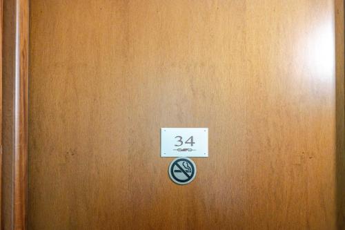 a door with a sign on it with the number at Hotel POSTA - 2 stars - Comfortable Stay in Ventimiglia in Ventimiglia
