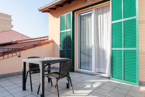 a patio with a table and chairs on a balcony at Hotel POSTA - 2 stars - Comfortable Stay in Ventimiglia in Ventimiglia