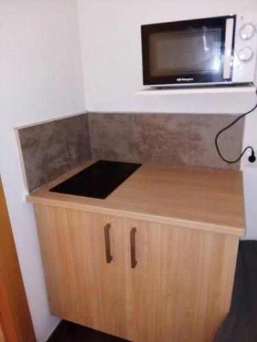 a small kitchen with a microwave on top of a counter at MT Boutique Suites y Apartamentos - Adults Only - in Mataró