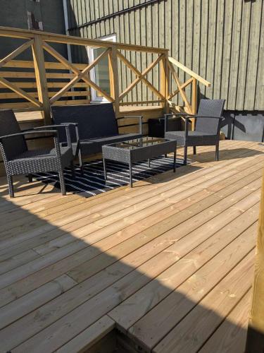 a group of chairs and a table on a deck at Hotell Silverborgen in Sala