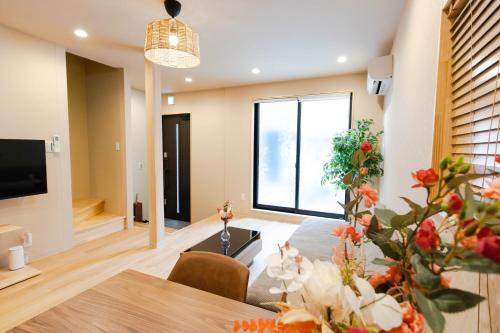 a living room with a table and a large window at Shinimamiya Ebisu 戎 in Osaka