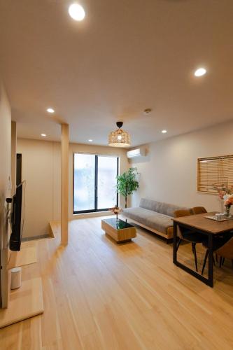 a living room with a couch and a table at Shinimamiya Ebisu 戎 in Osaka